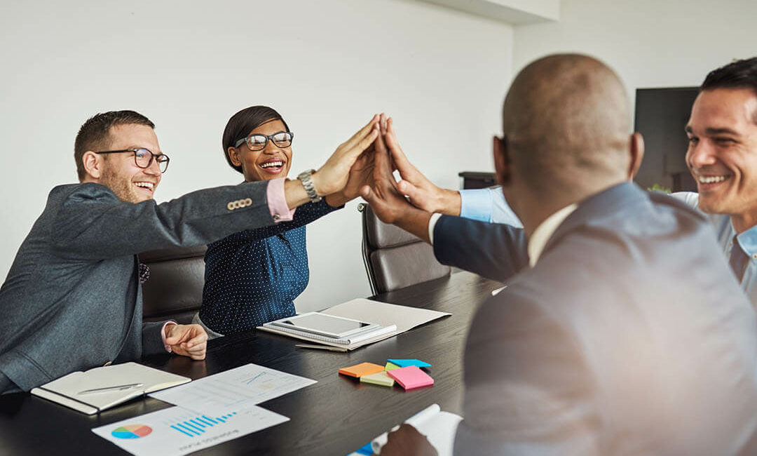 Jubilant multiracial business team cheering